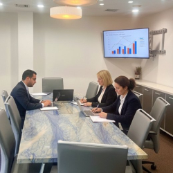 Team meeting in a professional boardroom with marble table and display, Marina Del Rey.