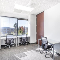 Private office with three workstations and large windows.
