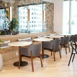 Cafe seating area with armchairs and built-in bench seating.