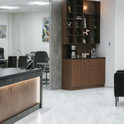 Lobby area featuring a floor-to-ceiling wooden display shelf and coffee bar.