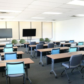 Large training room with rows of desks and blue chairs, 1903 Central Drive, Bedford, Texas.. Click for details.