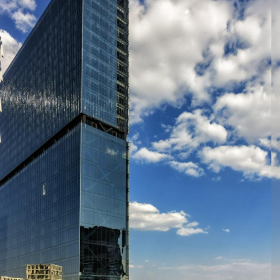 Exterior view of the glass-facade skyscraper at 1254, Avenida de las Américas.. Click for details.