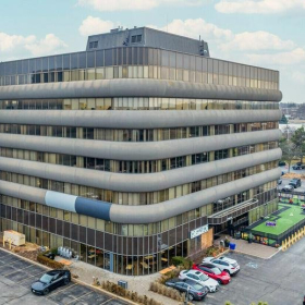 Exterior view of the tiered office building at 710, Dorval Drive surrounded by parking.. Click for details.
