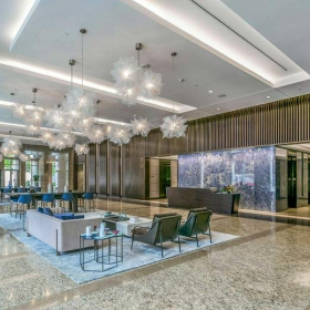 Grand modern lobby with marble floors and decorative bubble chandeliers.. Click for details.