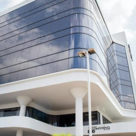 Exterior view of the modern glass-facade Torre Banistmo building in Panama City.. Click for details.